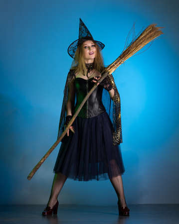 Young woman witch conjures, woman in costume on halloween