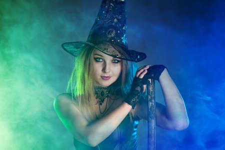Young woman witch conjures, woman in costume on halloween