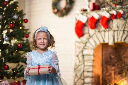 Baby girl in christmas interior with fireplaceの写真素材