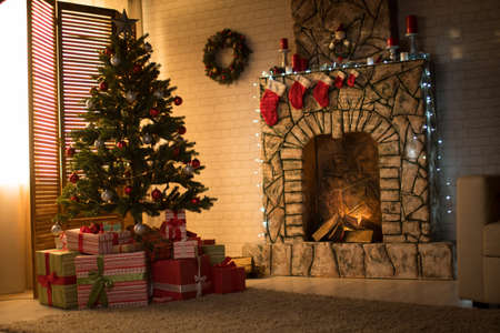 Christmas interior with Christmas tree and fireplaceの写真素材