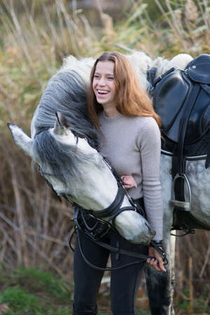 Young woman with a horse