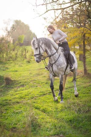 Young woman with a horseの写真素材