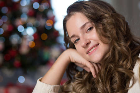 Teen girl in the room decorated for Christmasの写真素材