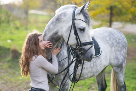 Young woman with a horseの写真素材