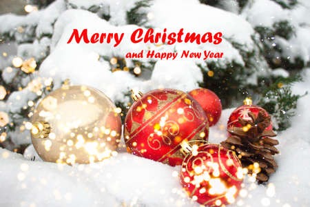 Christmas tree fir branches and decoration with snow, blurred, sparking, glowing winter background...