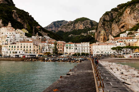 AMALFI, ITALY NOVEMBER 7 2019: Amalfi city view from the pier directly to the city, houses, fortress and sea beachのeditorial素材