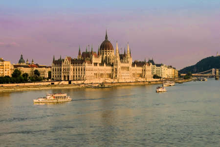 BUDAPEST, HUNGARY JULY 29, 2019: Beautiful evening view on Hungarian Parliament Building along Danube River with cruise ships on natural background. Text copy space.のeditorial素材