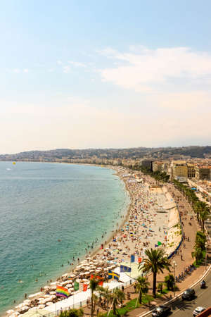 NICE, FRANCE - AUGUST 6, 2019 - Beautiful beach Promenade des Anglais in old city center of Nice. Natural background view. Mediterranean tourist destination, French riviera, Cote d'azur, Europe.のeditorial素材