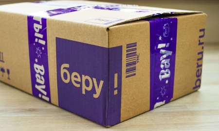 Moscow, Russia - March 17 2020: Beru Shipping Boxe closed close up on light natural wooden Backgroundのeditorial素材