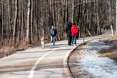 Moscow, Russia 22 February 2020: People walking in Izmailovsky park. Men running with dog. Leasure activitiesのeditorial素材