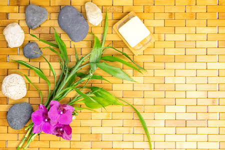 Spa, zen, massage concept. Bamboo leaves, bath soap dish, white black stones, orchidの写真素材
