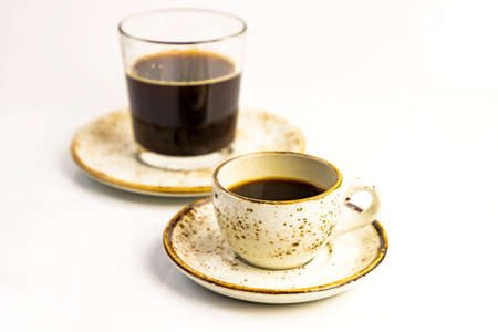 Morning coffee concept. Various coffe cup with saucer and glass on plate on white background. Selective soft focus. Text copy spaceの写真素材