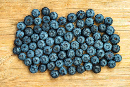 Blueberries ripe on wooden table background. Harvesting concept. Top viewの写真素材