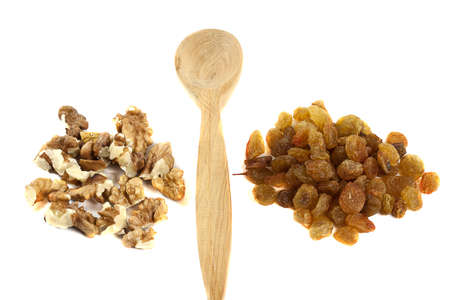 wooden spoon with nuts and raisins isolated on white backgroundの写真素材