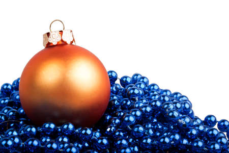 Orange Christmas ball and blue beads on a white backgroundの写真素材