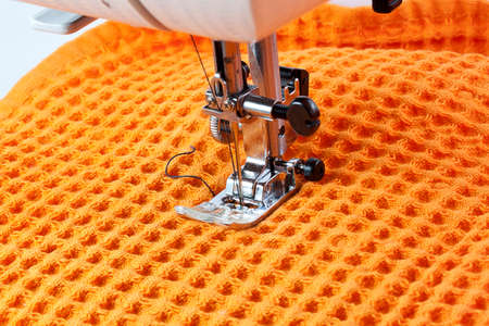 sewing machine working part with orange cloth