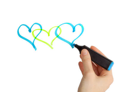 Female hand drawing hearts with blue marker on a white backgroundの写真素材