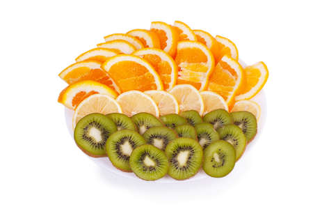 sliced ââfruit on a plate isolated on white backgroundの写真素材