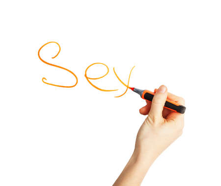 Female hand writing the word "sex" with orange marker on a white の写真素材