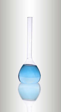 Laboratory blue glassware on gray の写真素材