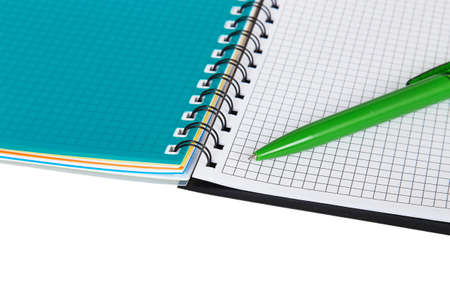 Open notebook with green pen isolated on white background