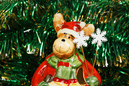 Christmas decorative deer on a green garland backgroundの写真素材