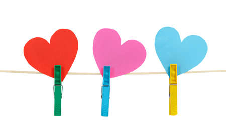 Three paper hearts on clothespins on a rope isolated on white backgroundの写真素材