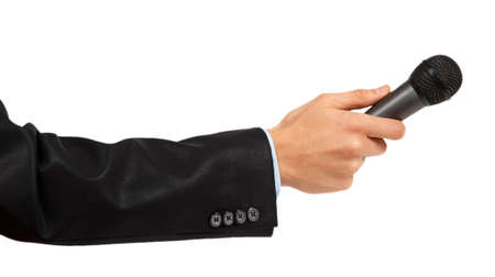 Man's hand in black suit holding a microphone isolated on white backgroundの写真素材