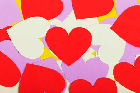 Paper red and purple hearts on a yellow backgroundの写真素材