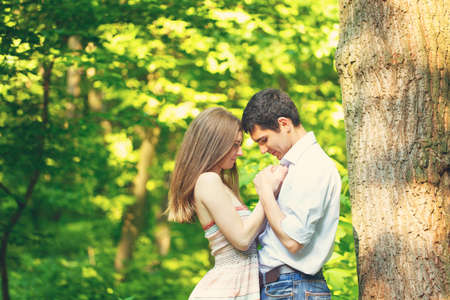 Lovers young man and woman walking in the summer park