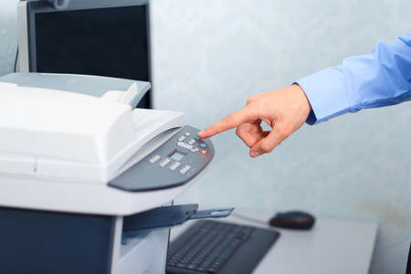Businessman working with printer in the officeの写真素材
