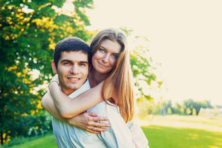 Lovers young man and woman walking in the summer parkの写真素材