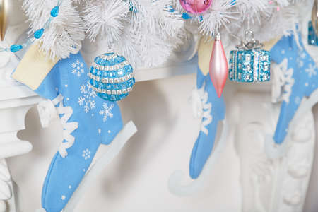 White garland above the fireplace with blue skates and toys