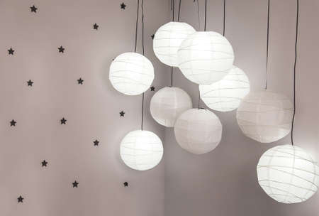 lanterns hanging from the ceiling, on the wall of stars in the roomの写真素材