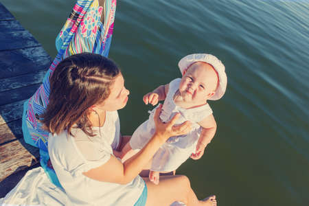 Mother and baby are resting on the river bankの写真素材