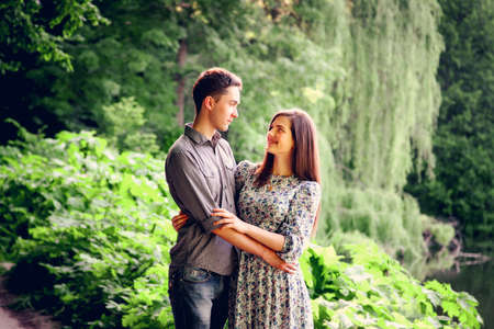Lovers young man and woman walking in the summer parkの写真素材