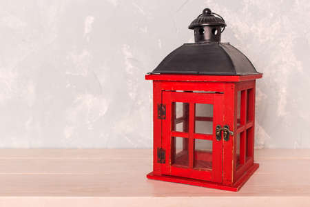red lantern on the wooden floor against the backdrop of a blue wallの写真素材