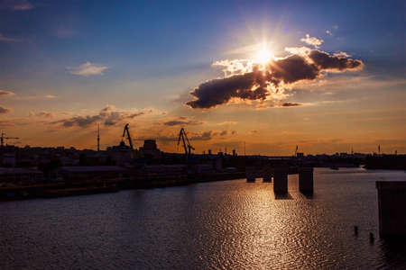 Industry area - Silhouette of an construction crane at sunsetの写真素材