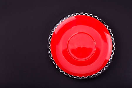 red saucer on a black backgroundの写真素材