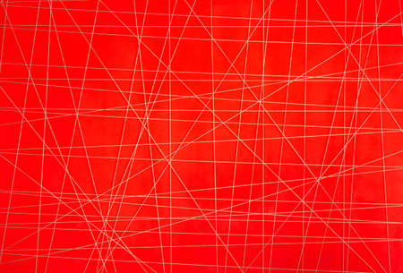 abstract white thread with irregular crossed lines on red backgroundの写真素材