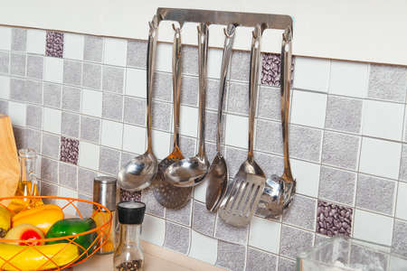 Kitchen tools. Set of tools for cooking. Hanging on the kitchen wall