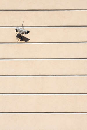 Security outdoor camera on the wall stripesの写真素材