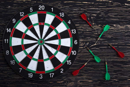 The darts isolated on dark wooden backgroundの写真素材
