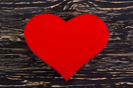 Read heart  on grunge dark wooden backgroundの写真素材