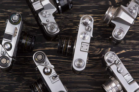vintage cameras on dark wooden background backgroundの写真素材