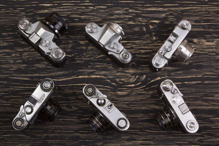 Old retro cameras on vintage wooden abstract backgroundの写真素材