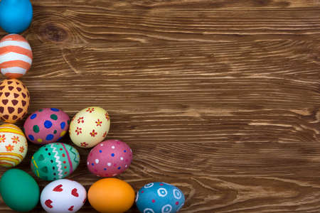 Painted Easter eggs on dark wooden background.の写真素材