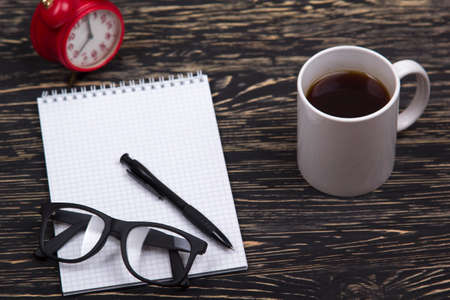 Mix of office supplies and gadgets on a wooden desk background. View from above.の写真素材