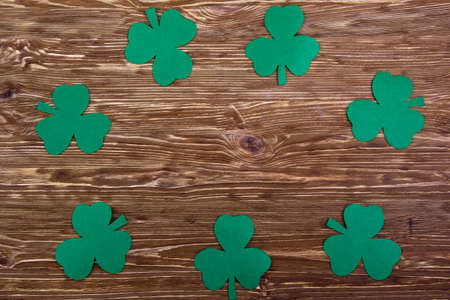 Fabric green clover leaves on brown wooden background.の写真素材