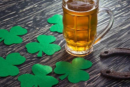 Shamrock clover, horseshoe and beer - symbol of holiday St Patrick's Day